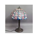 A Tiffany style lamp with coloured glass shade, 23