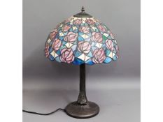 A Tiffany style lamp with coloured glass shade, 23