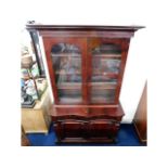 A Victorian mahogany bookcase with serpentine fron