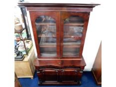 A Victorian mahogany bookcase with serpentine fron