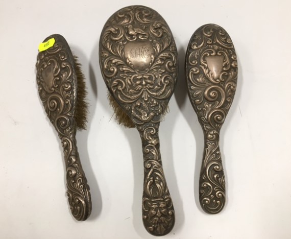 Three silver backed brushes a/f