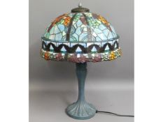 A Tiffany style lamp with coloured glass shade, 26