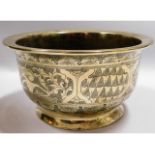 A 19thC. brass bowl with chased decor, 6.75in diam