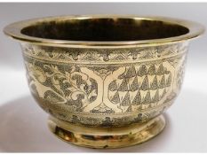 A 19thC. brass bowl with chased decor, 6.75in diam