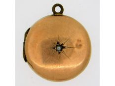 A 9ct gold antique locket, some dents, set with pe