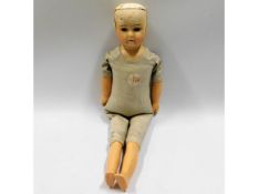 An porcelain headed doll with leather body, 15.25i