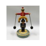 An early 20thC. wood & metal folk art balance toy