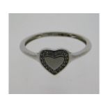 A 9ct white gold ring with heart shape design set