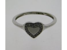 A 9ct white gold ring with heart shape design set