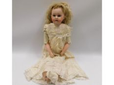 An German porcelain headed doll with leather joint