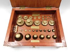 A cased set of weights with plaque to box "W & T A