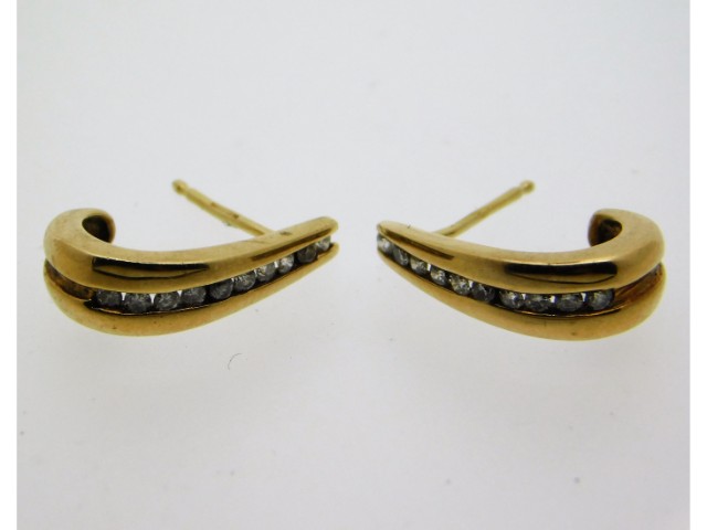 A pair of 9ct gold earrings set with approx. 0.2ct