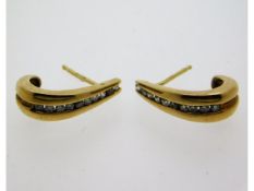 A pair of 9ct gold earrings set with approx. 0.2ct