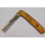 A 19thC. white metal comb with bone handle, possib