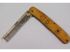 A 19thC. white metal comb with bone handle, possib