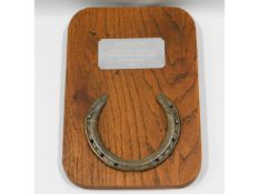 An oak mounted horseshoe of the legendary champion