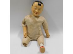 An Oriental man doll with composite head, lacking