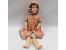An German porcelain headed doll, 19.5in tall