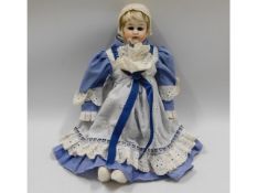 A porcelain headed doll, leather body & legs, 13.5