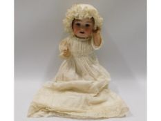 A German porcelain headed doll, 12in tall