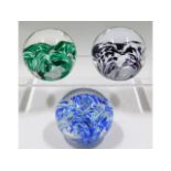Three Liskeard glass paperweights, two dated 1977
