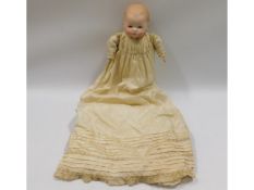 An Armand Marseille porcelain headed doll in silk