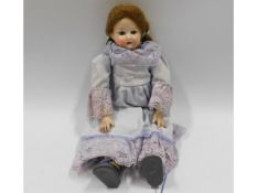 A German porcelain headed doll, 12in tall