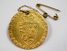 A George III 1795 22ct gold guinea, hole & pin for