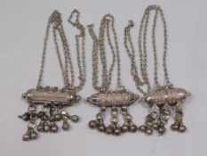 Three Omani white metal amulets, 127.4g