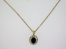 A 9ct gold chain & pendant set with sapphire & pas