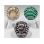 Three Liskeard glass paperweights, two dated 1977