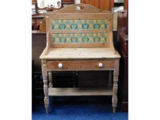 A Victorian stripped pine washstand with tiled bac