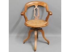 An antique oak captains chair with cane seat, some