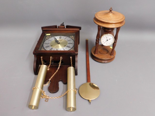 An oak mounted Hermle portico style clock twinned