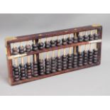 A Chinese abacus twinned with a small modern oil p