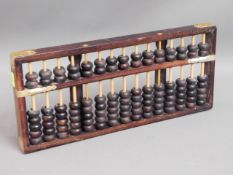 A Chinese abacus twinned with a small modern oil p