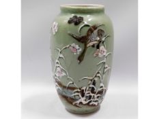 A Japanese celadon vase with relief blossom decor,