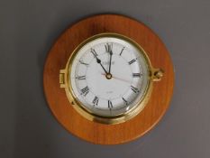 A brass Vetus wall mounted quartz ships clock