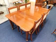 A mahogany extending dining table with six upholst
