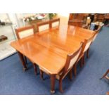 A mahogany extending dining table with six upholst