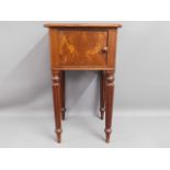 An antique mahogany pot cupboard with tapered gadr