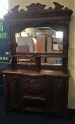 An ornate mahogany dresser with mirrored back, 53i