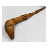 A carved folk art walking cane with Celtic love kn