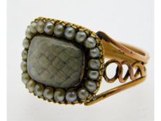 A 19thC. yellow metal mourning ring set with seed