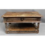 An antique oak carved low level table with drawer,