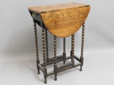 A small 1920's oak drop leaf table with drawer, 28