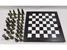 A 15.5in square marble chess board with brass pieces, king 4in tall