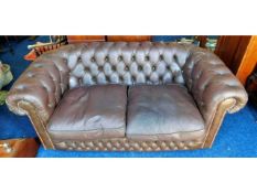 A brown leather Chesterfield style two seater club