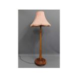 A wooden standard lamp, 66in tall to top of shade
