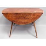 An Ercol elm dining table, 48in wide extended x 44